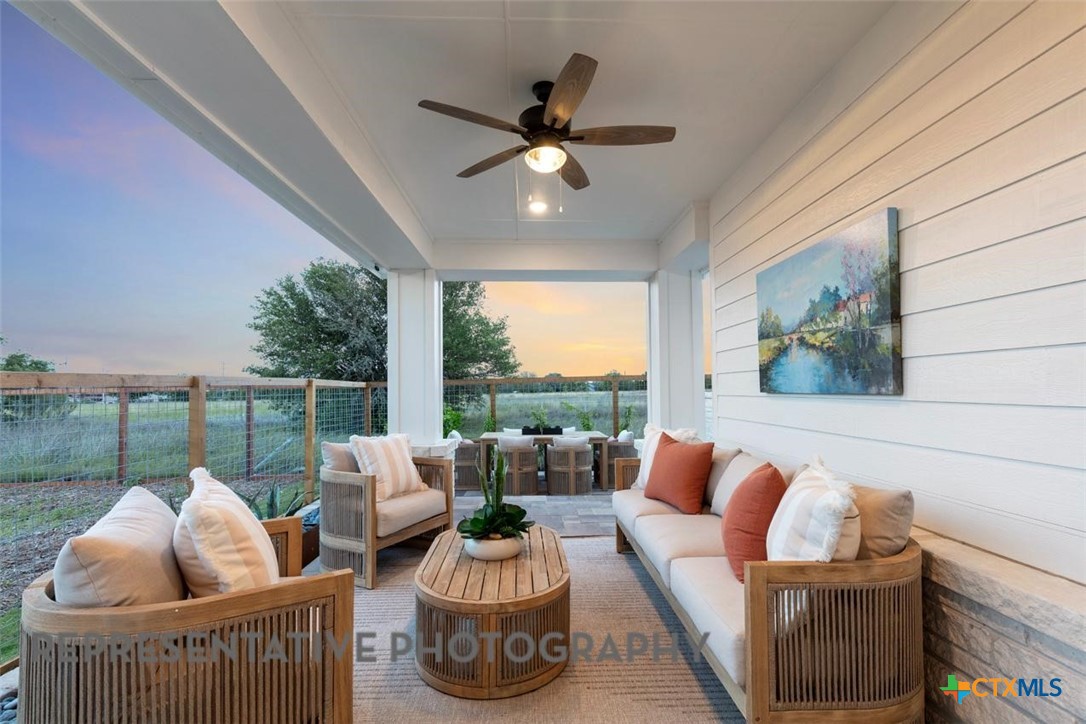 12213 Moon Pool Schertz, TX 78154 - Photo 27 of 32 a living room with furniture and a floor to ceiling window
