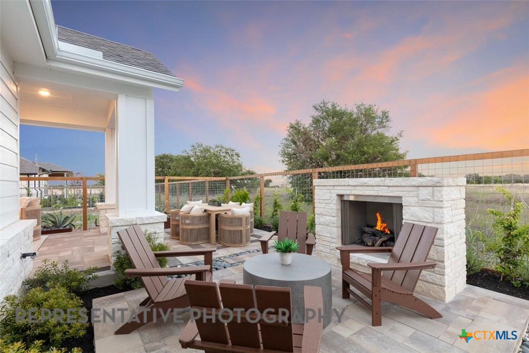 12213 Moon Pool Schertz, TX 78154 - Photo 31 of 32 a view of a patio with a dining table and chairs with two potted plants