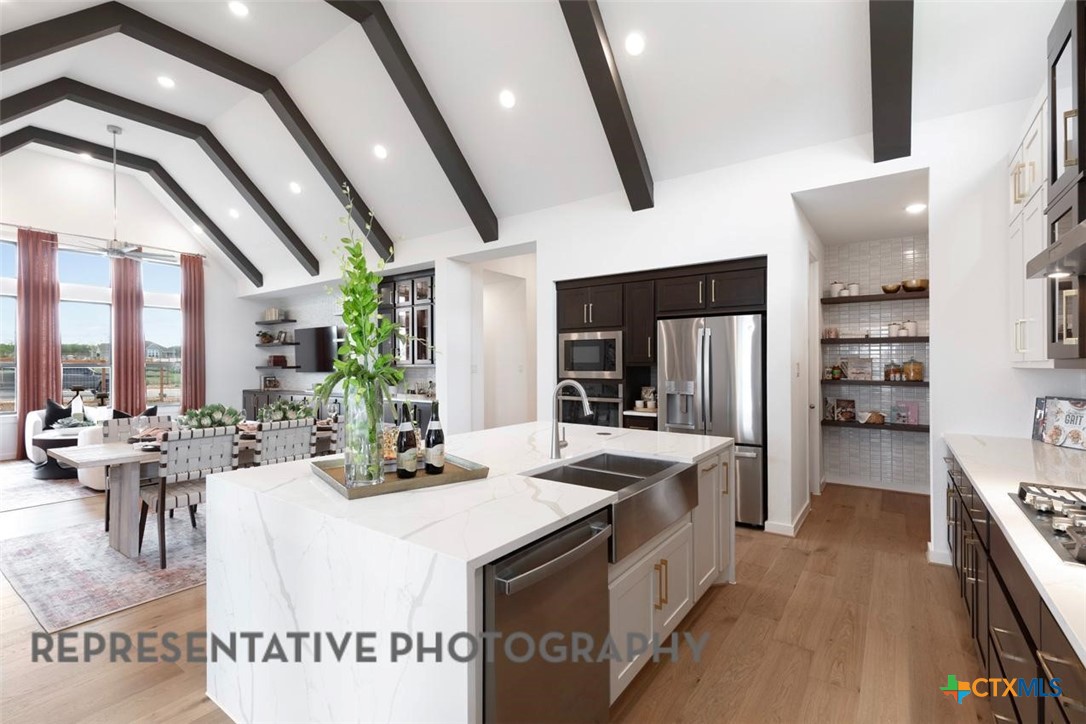 12213 Moon Pool Schertz, TX 78154 - Photo 5 of 32 a kitchen that has a lot of cabinets a sink and appliances
