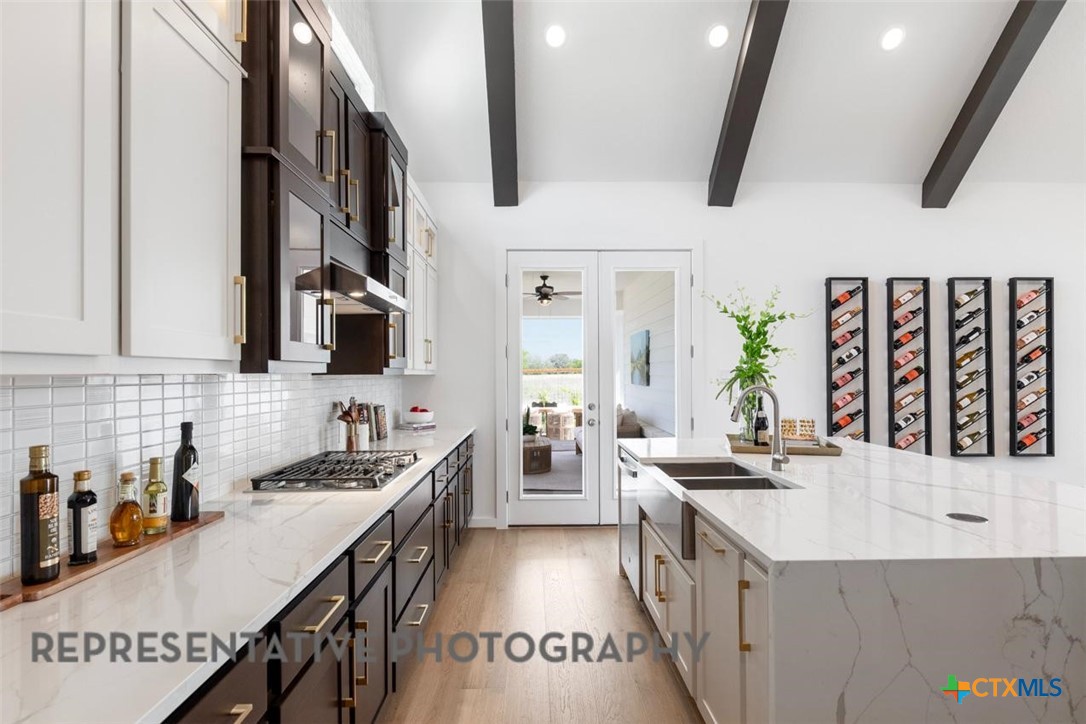 12213 Moon Pool Schertz, TX 78154 - Photo 6 of 32 a kitchen with a sink stove and cabinets