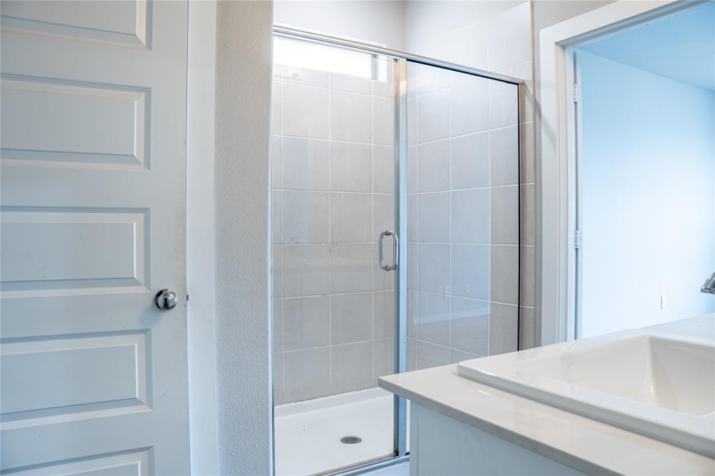 348 Braves Way Lavon, TX 75166 - Photo 12 of 29 a bathroom with a shower and a sink