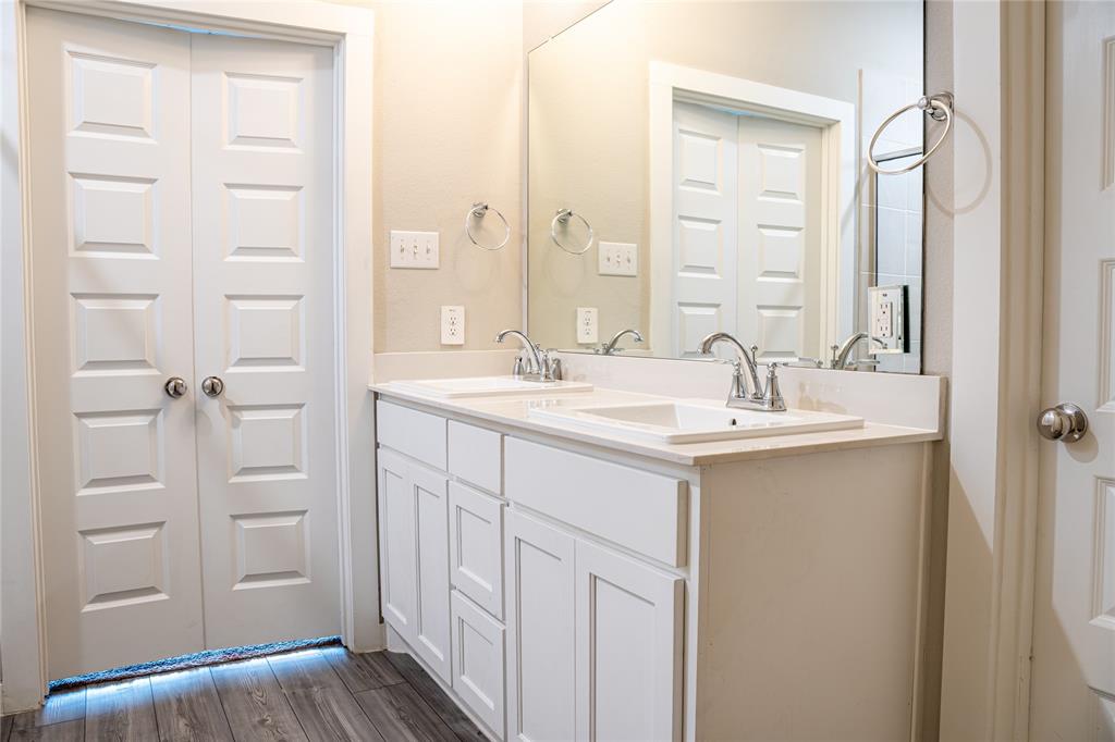 348 Braves Way Lavon, TX 75166 - Photo 14 of 29 a bathroom with a double vanity sink and a mirror
