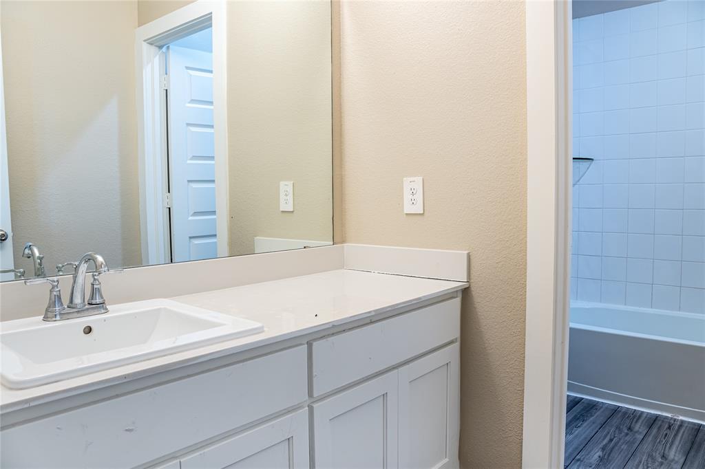 348 Braves Way Lavon, TX 75166 - Photo 21 of 29 a bathroom with a sink and a bathtub