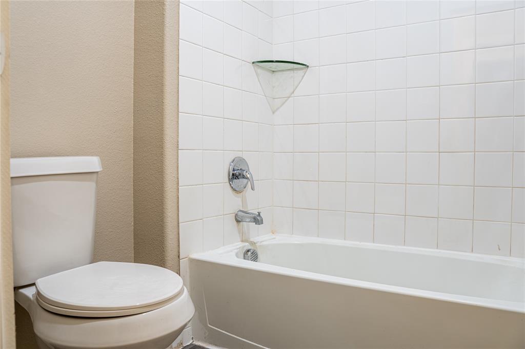 348 Braves Way Lavon, TX 75166 - Photo 22 of 29 a white toilet sitting next to a bath tub