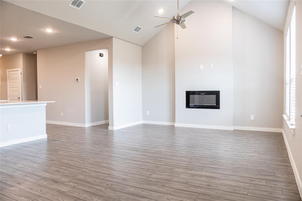 348 Braves Way Lavon, TX 75166 - Photo 10 of 29 wooden floor in an empty room with a window