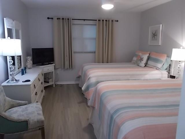 14001 Gulf Boulevard, Unit 407 Madeira Beach, FL 33708 - Photo 17 of 39 a bed room with a bed window and a television