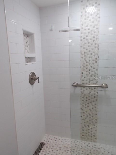 14001 Gulf Boulevard, Unit 407 Madeira Beach, FL 33708 - Photo 23 of 39 a bathroom with a shower