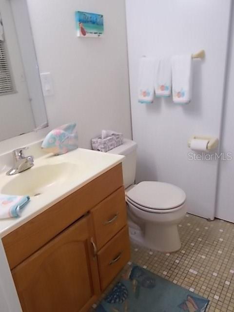 14001 Gulf Boulevard, Unit 407 Madeira Beach, FL 33708 - Photo 27 of 39 a bathroom with a sink a toilet and mirror