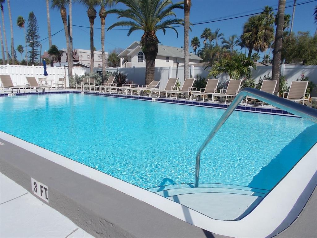 14001 Gulf Boulevard, Unit 407 Madeira Beach, FL 33708 - Photo 35 of 39 a view of swimming pool with outdoor seating and lake view