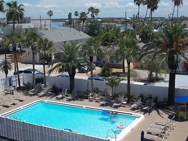 14001 Gulf Boulevard, Unit 407 Madeira Beach, FL 33708 - Photo 36 of 39 a view of a house with swimming pool and sitting area