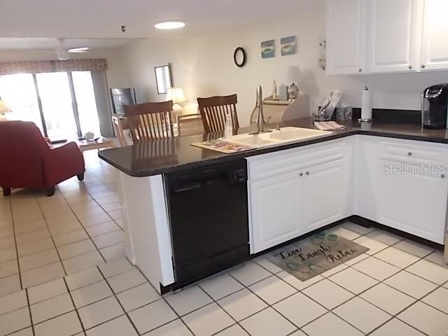 14001 Gulf Boulevard, Unit 407 Madeira Beach, FL 33708 - Photo 6 of 39 a kitchen with a sink cabinets and appliances