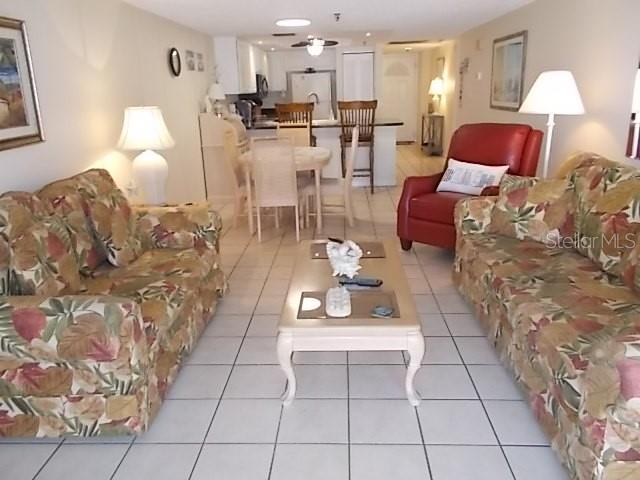 14001 Gulf Boulevard, Unit 407 Madeira Beach, FL 33708 - Photo 10 of 39 a living room with furniture and a table