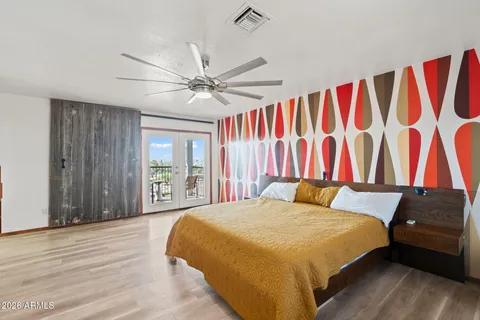 a bedroom with a bed and a flat screen tv