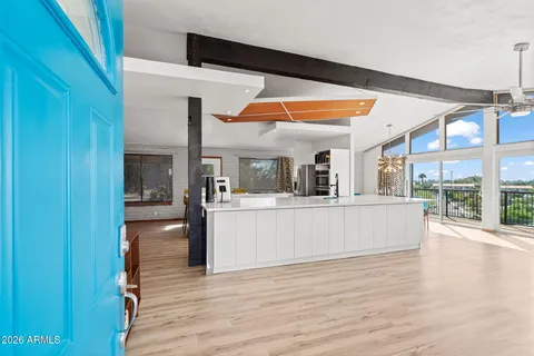 a view of living room with kitchen island furniture and wooden floor
