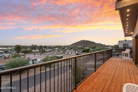 a view of a balcony with wooden floor and city view