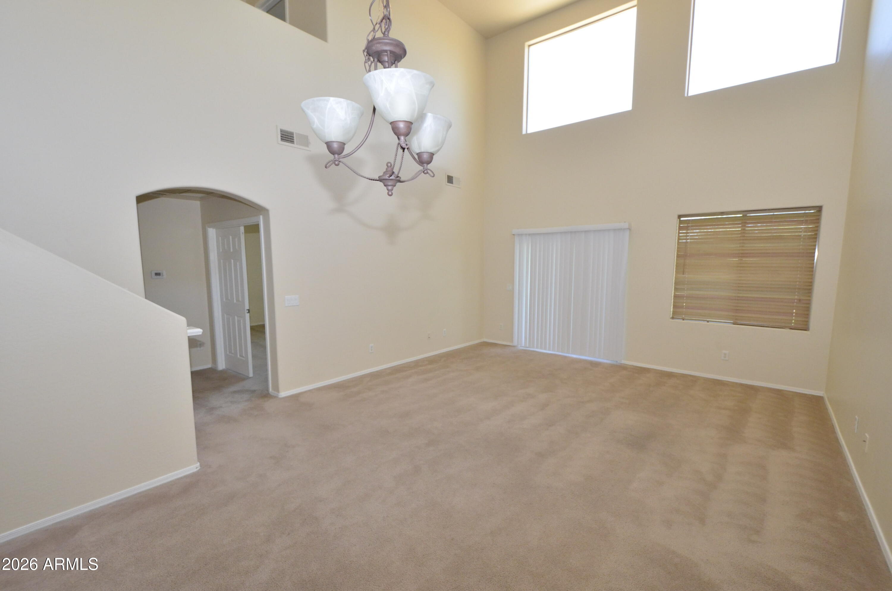 3995 East Trigger Way Gilbert, AZ 85297 - Photo 6 of 23 a view of an empty room with a chandelier fan