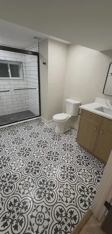 a bathroom with a sink a toilet and a mirror