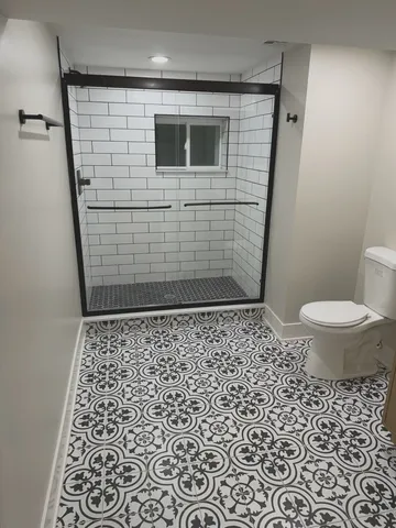 a bathroom with a sink a toilet and a shower