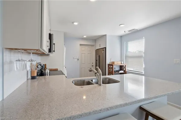 a view of a kitchen with a sink and a large window
