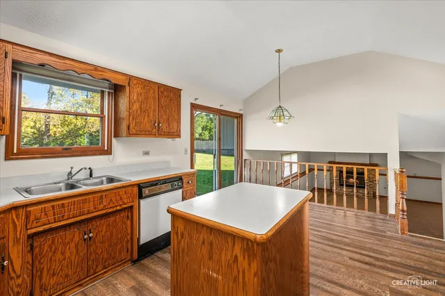 a kitchen that has a sink a stove and a wooden floors
