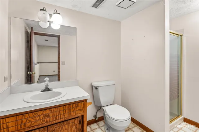 a bathroom with a sink toilet and a mirror