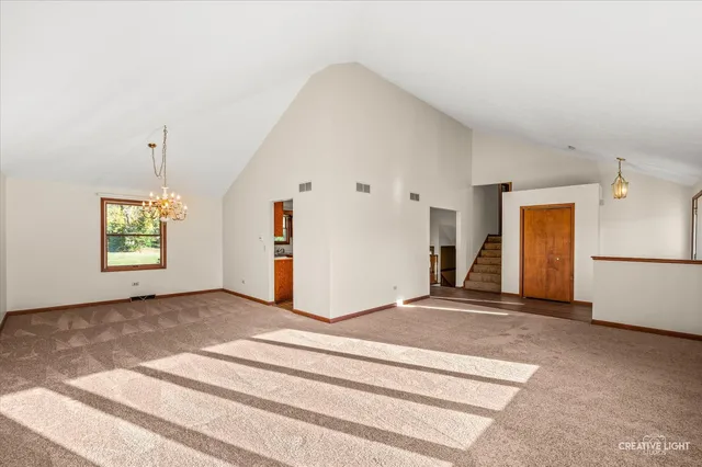a view of a livingroom with wooden floor and a window