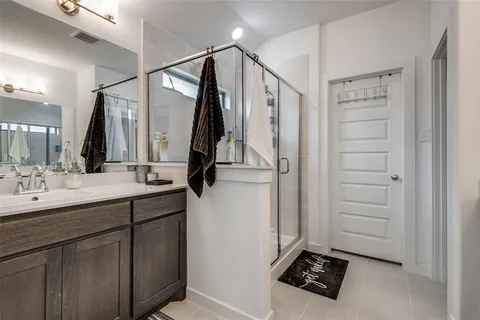 a bathroom with a sink a mirror and a shower