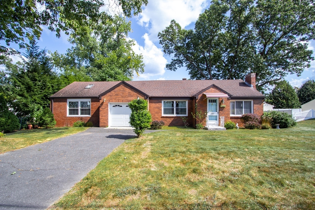 267 Winton Street Springfield, MA 01118 - Photo 2 of 28 a front view of a house with a yard and garage