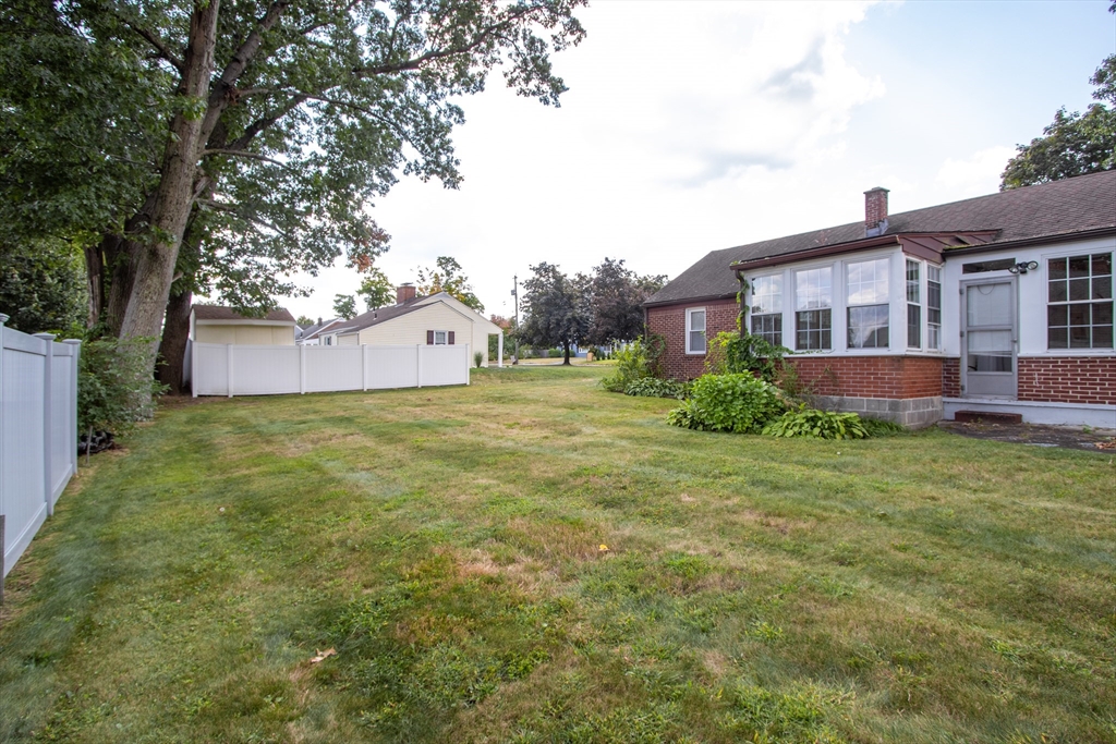 267 Winton Street Springfield, MA 01118 - Photo 26 of 28 a brick house with a big yard and large trees
