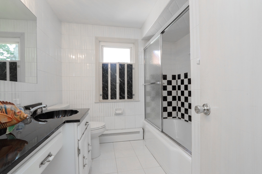 267 Winton Street Springfield, MA 01118 - Photo 9 of 28 a bathroom with a bathtub and a shower