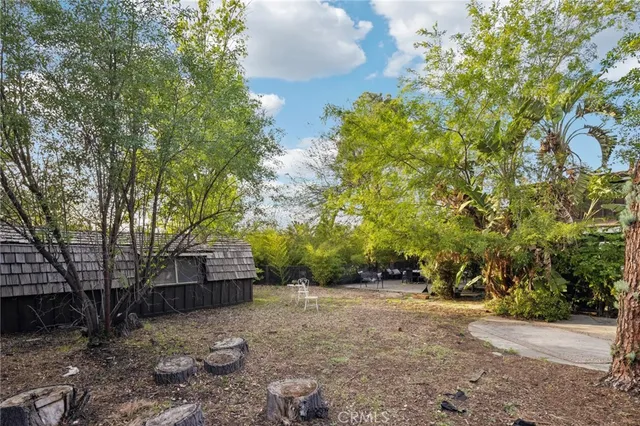 a backyard of a house with table and chairs