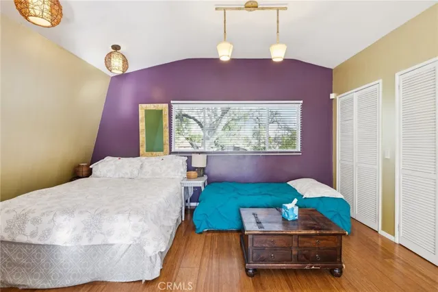 a kitchen that has a lot of cabinets appliances and a window