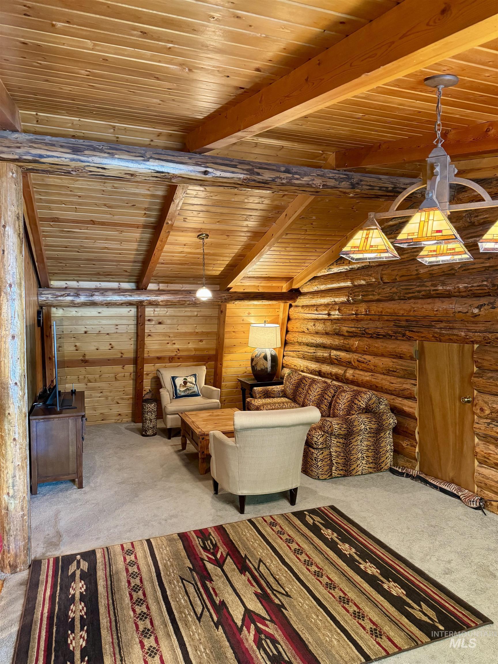 62 Bell Rapids Road Hagerman, ID 83332 - Photo 20 of 34 Exposed log walls and natural wood ceiling with exposed beams