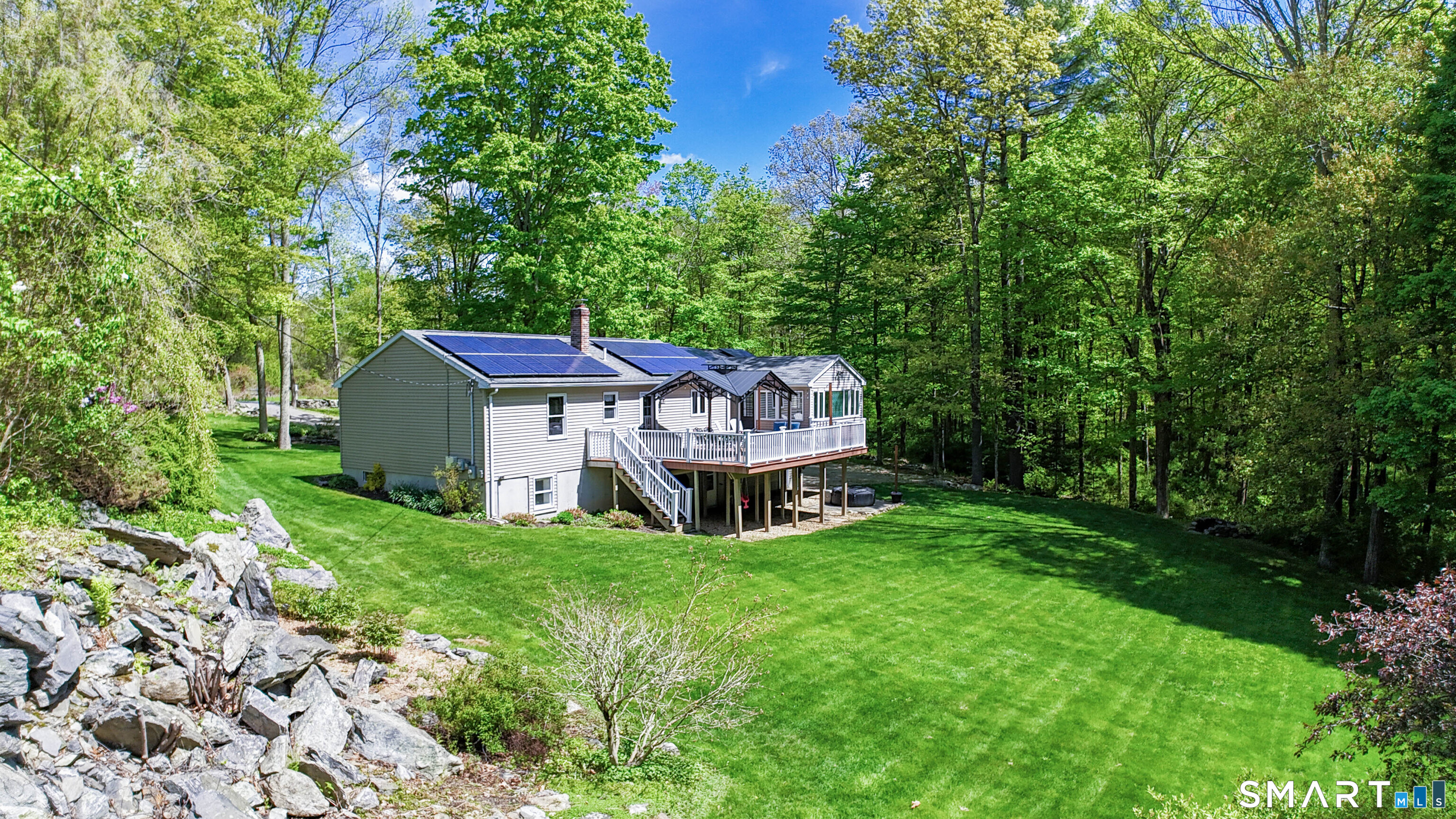309 O'Leary Road Thompson, CT 06277 - Photo 2 of 40 a view of a house with a small yard and large trees