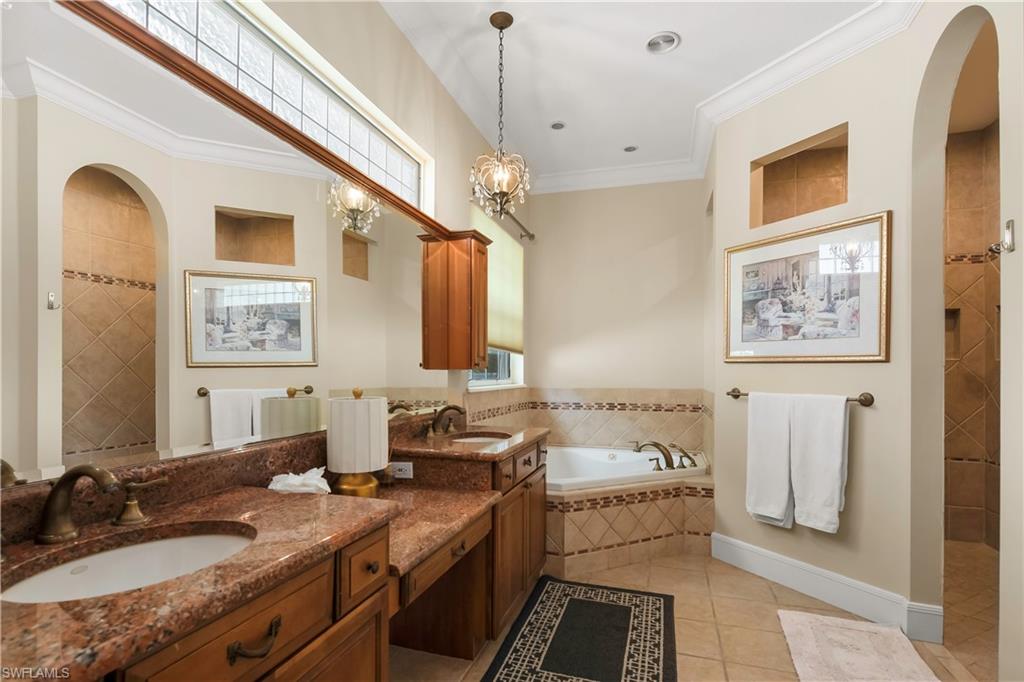 649 Bow Line Drive Naples, FL 34103 - Photo 12 of 31 a bathroom with double vanity sinks a mirror and a shower