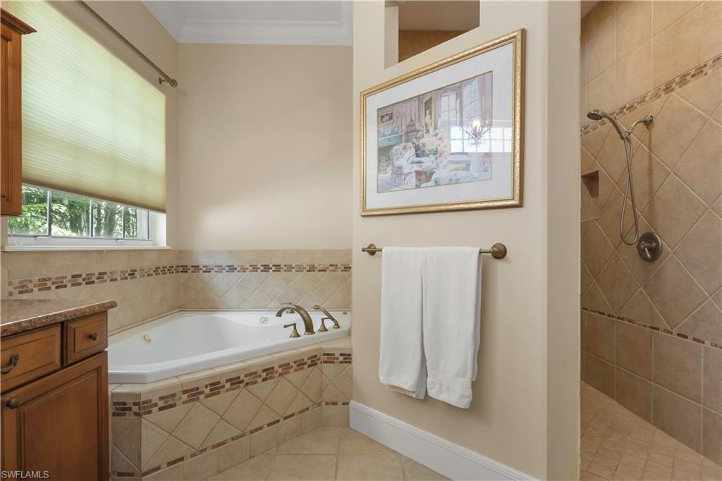 649 Bow Line Drive Naples, FL 34103 - Photo 13 of 31 a bathroom with a tub a sink and a shower