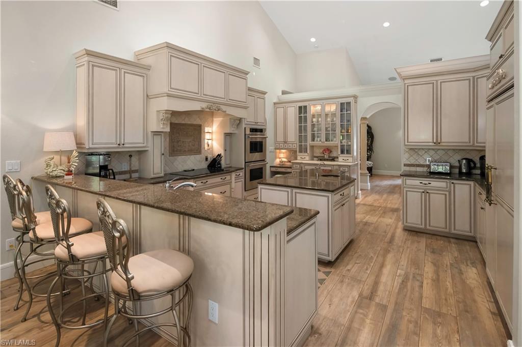 649 Bow Line Drive Naples, FL 34103 - Photo 15 of 31 a kitchen with stainless steel appliances granite countertop a sink a stove and cabinets