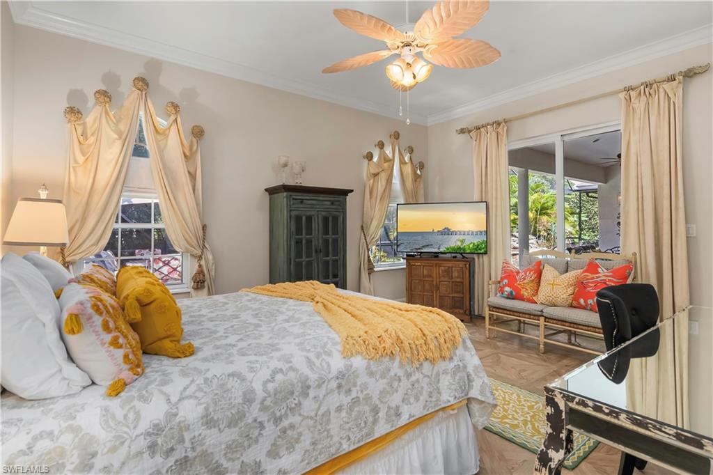 649 Bow Line Drive Naples, FL 34103 - Photo 21 of 31 a bedroom with a bed and a chandelier