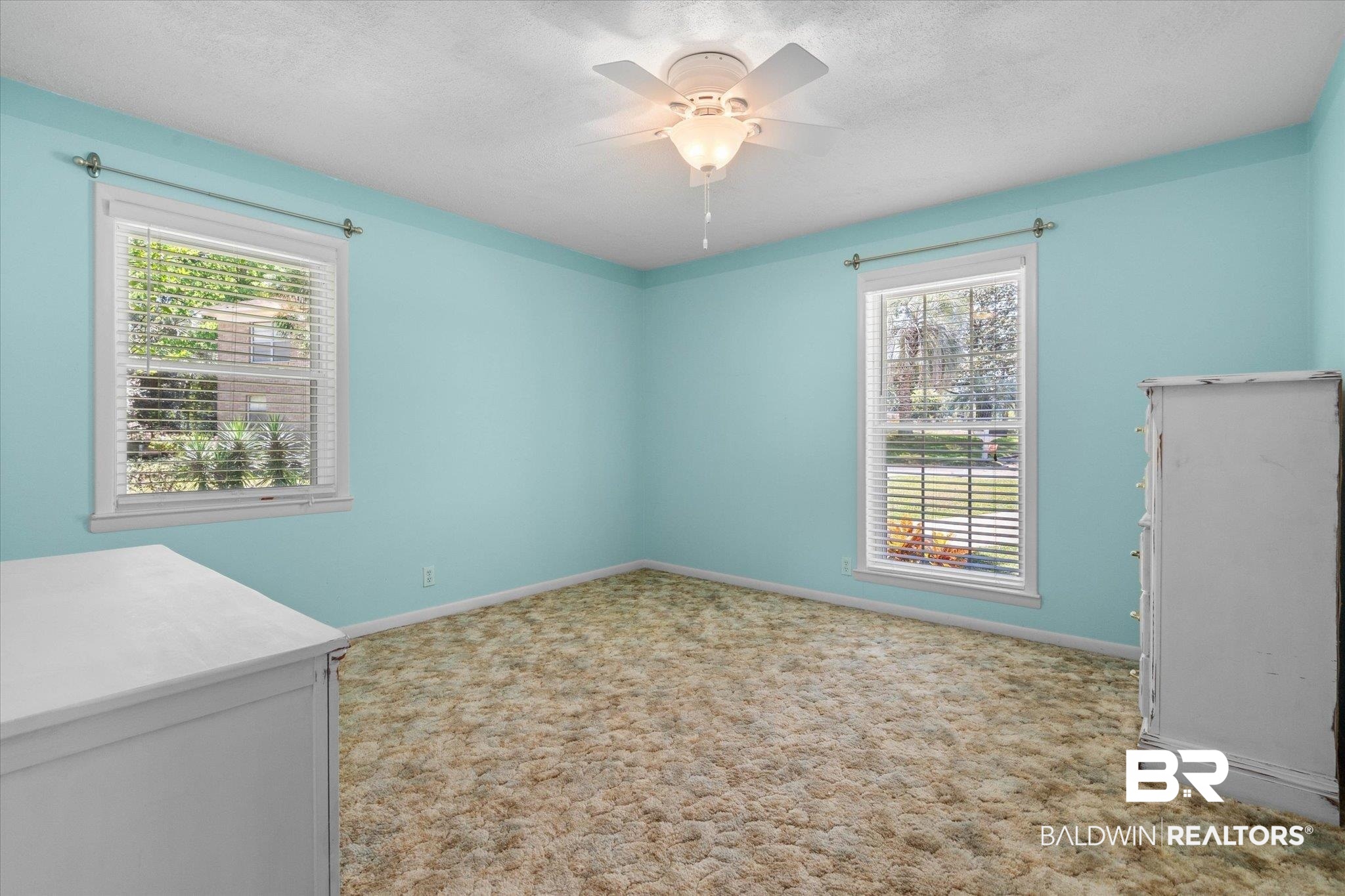 706 Sutherland Drive Chickasaw, AL 36611 - Photo 16 of 33 Empty room with carpet, ceiling fan, baseboards, and plenty of natural light