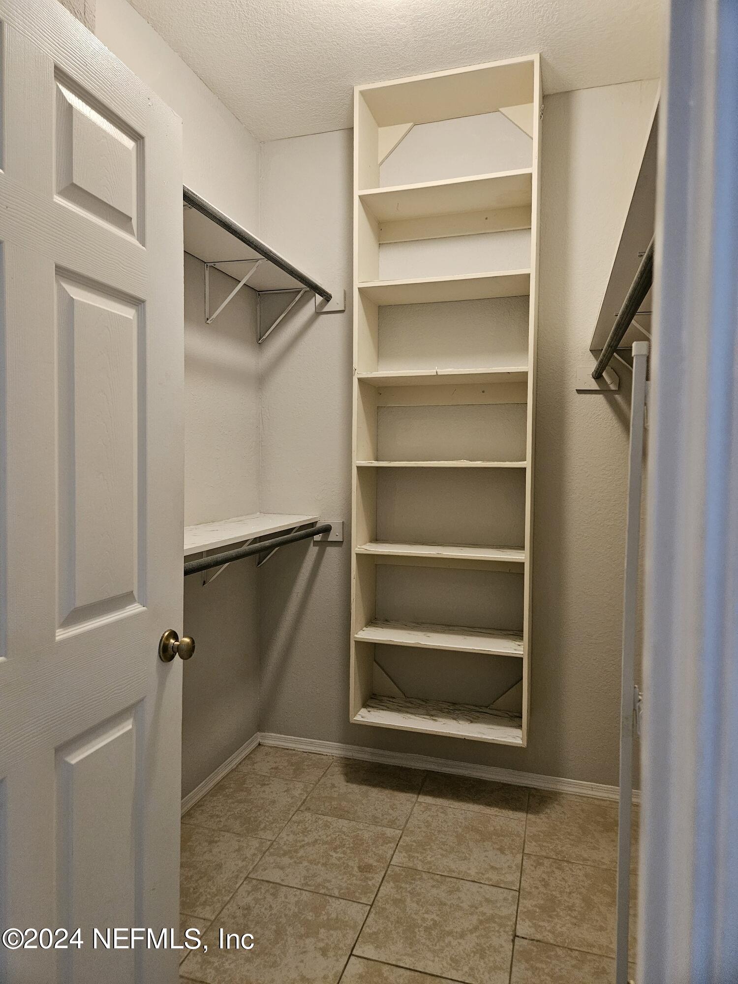 13810 Sutton Park Drive North, Unit 916 Jacksonville, FL 32224 - Photo 11 of 17 a view of walk in closet with empty racks