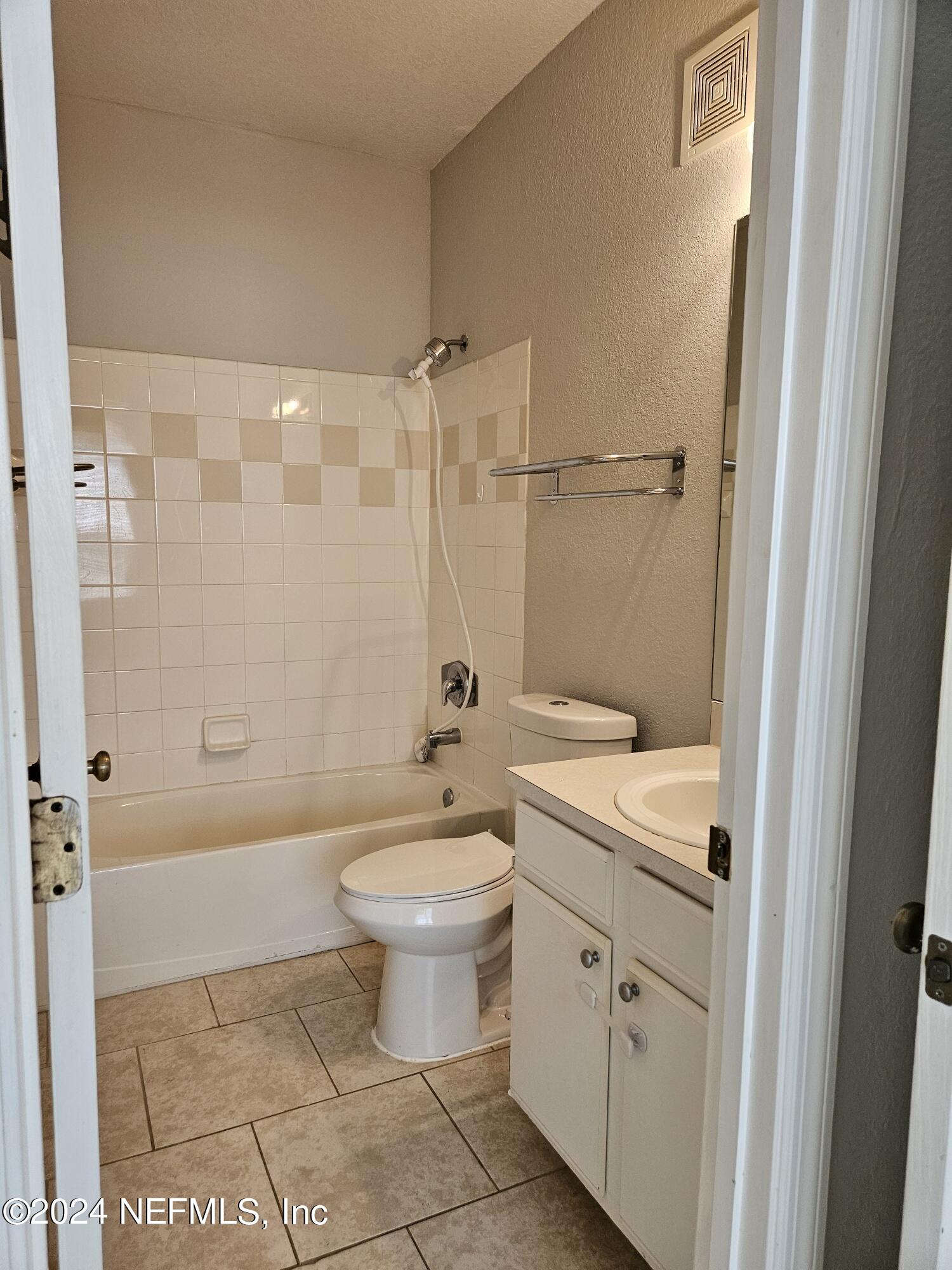 13810 Sutton Park Drive North, Unit 916 Jacksonville, FL 32224 - Photo 15 of 17 a bathroom with a sink a toilet and shower