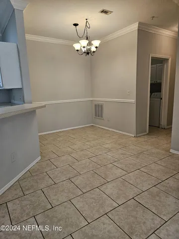 a kitchen with stainless steel appliances a sink counter top space cabinets and a window