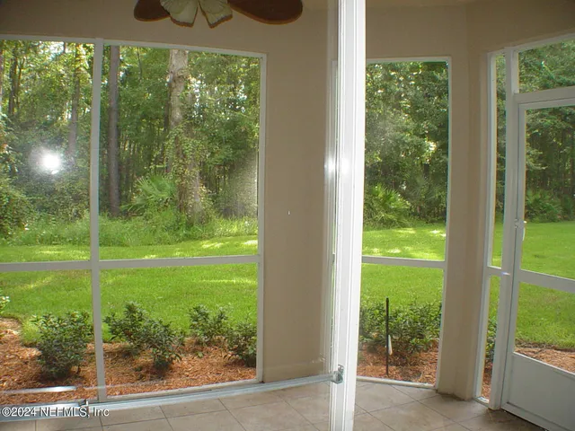 a view of a livingroom with a ceiling fan and window