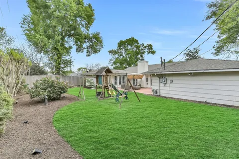 a view of a house with a yard and sitting area