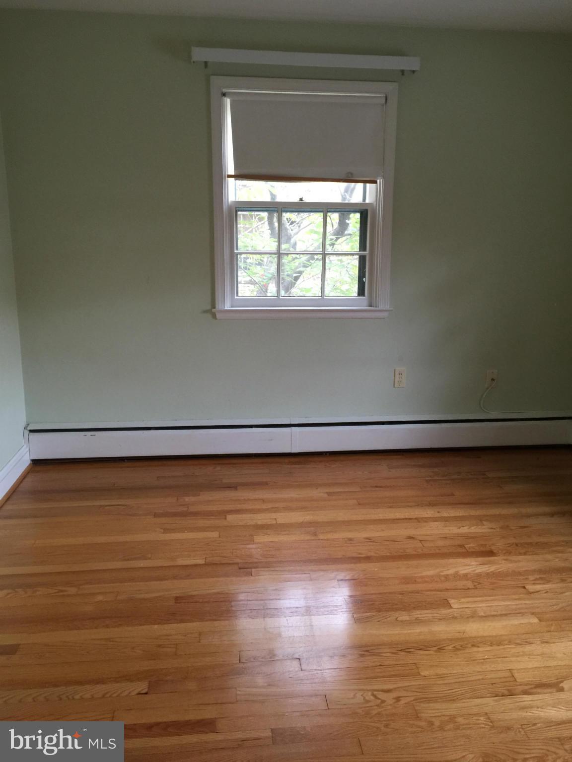 104 Croydon Road Baltimore, MD 21212 - Photo 7 of 13 a view of a room with wooden floor and a window