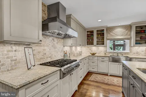 a spacious bathroom with a granite countertop sink mirror and shower