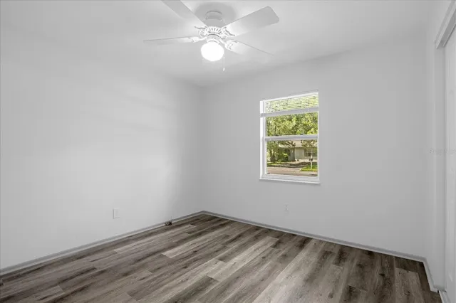 wooden floor in an empty room with a window