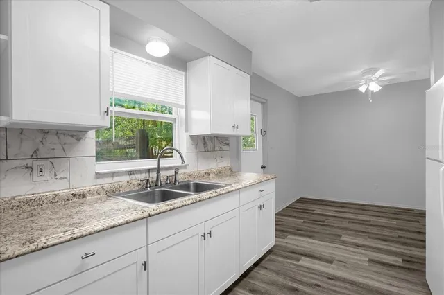 a kitchen with white cabinets and white appliances