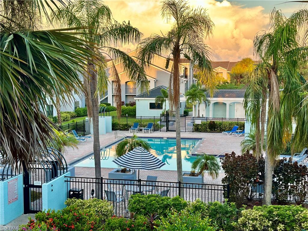 13615 Eagle Ridge Drive, Unit 1614 Fort Myers, FL 33912 - Photo 18 of 34 Illuminated spa and pool area featuring extensive paver decking
