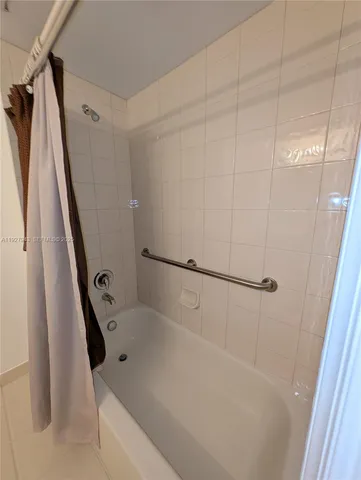 a bathroom with a sink a toilet a mirror and shower